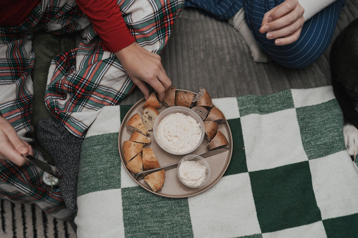 Newlyweds have an at home picnic with bread and dip