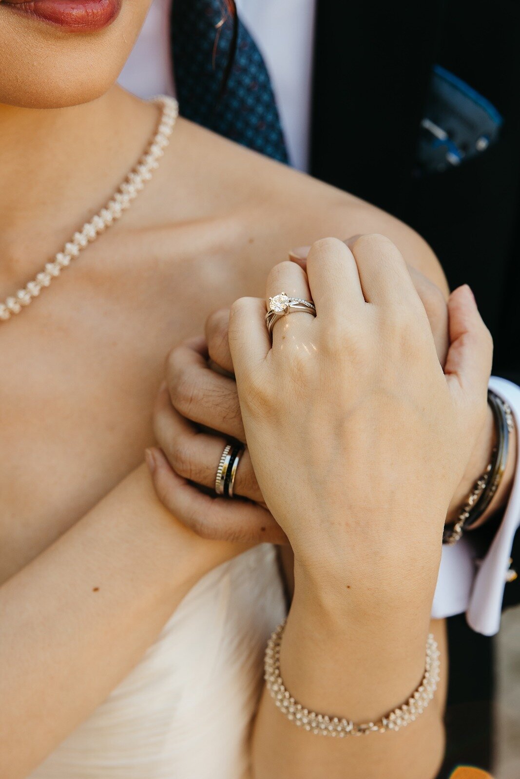 Photo of bride and grooms hand with their wedding rings