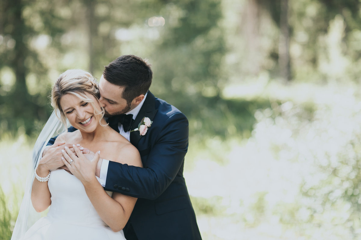 snuggling bride & groom wedding day