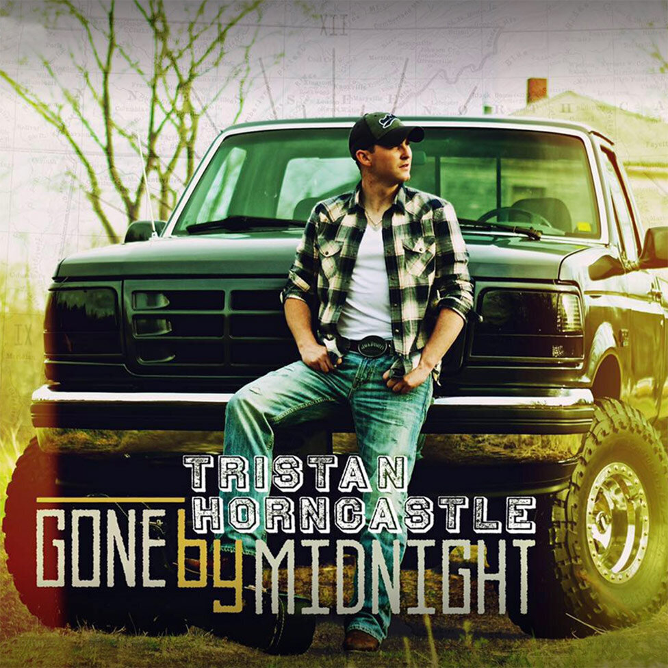 Single Cover Title Gone By Midnight Country Artist Tristan Horncastle standing in front of grill of big truck wearing plaid shirt and baseball cap thumbs in the pockets of his jeans