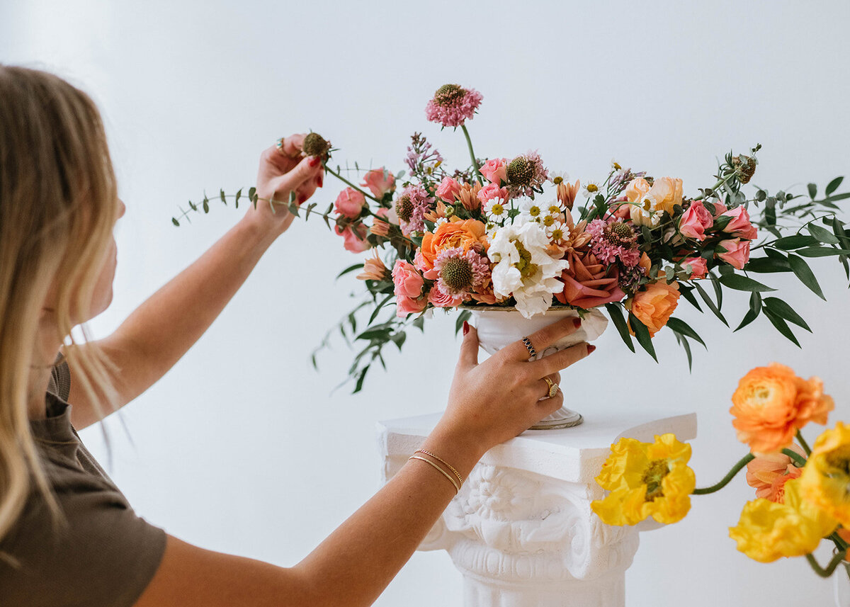 Florist fine-tuning a custom floral arrangement