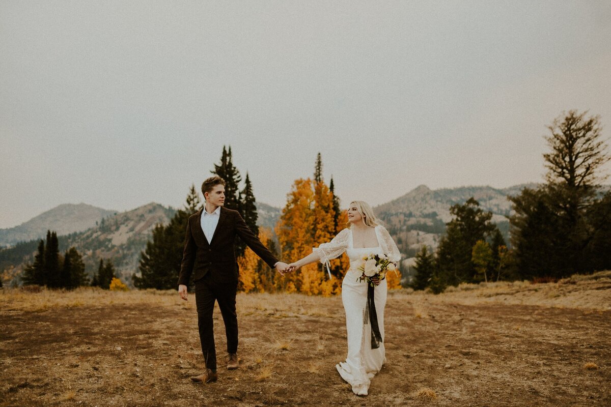 Bride and groom walking in the mountains