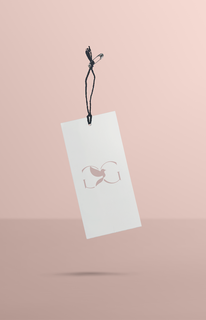 Minimalist blush and white product hang tag with the Gaby & Grace monogram logo and black string, designed to complement the brand’s refined packaging system.