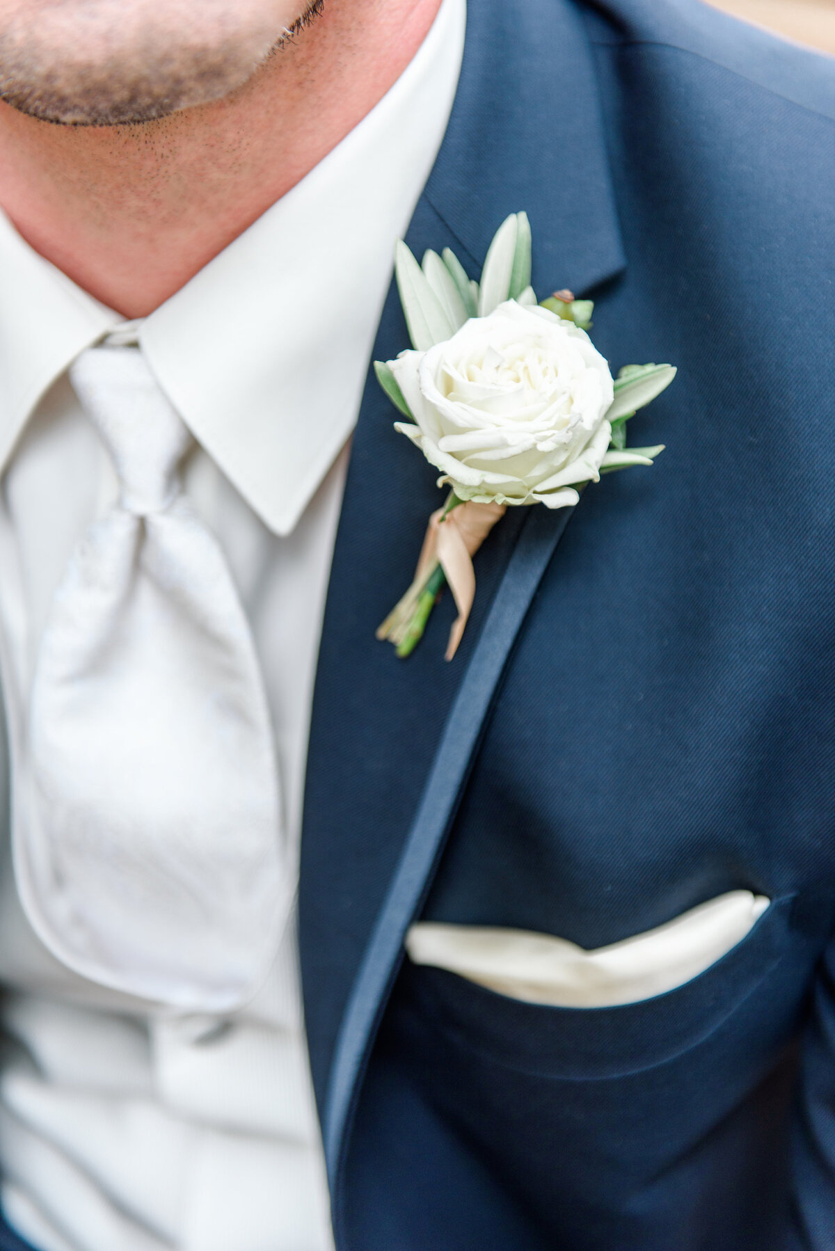 close up of navy tux with boutonniere