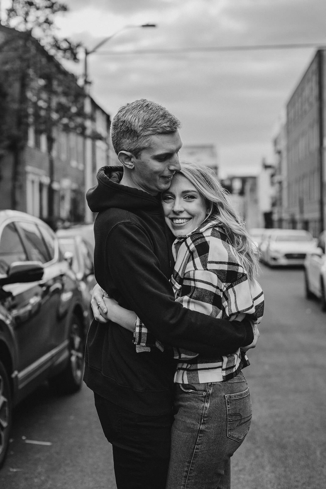 A person hugging their partner in the middle of a road 