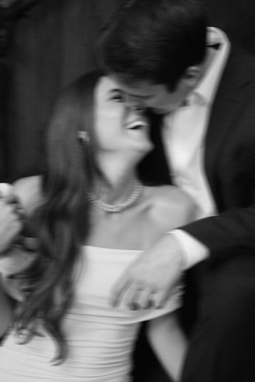 blurry black and white photo of guy kissing girl on nose