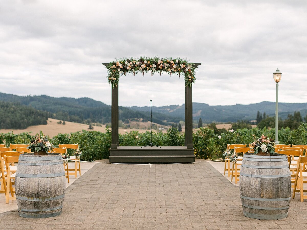 Wedding ceremony arch at Maysara Winery with floral design across the top.