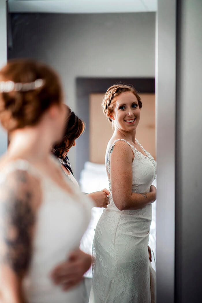 bride-looks-at-dress-in-mirror