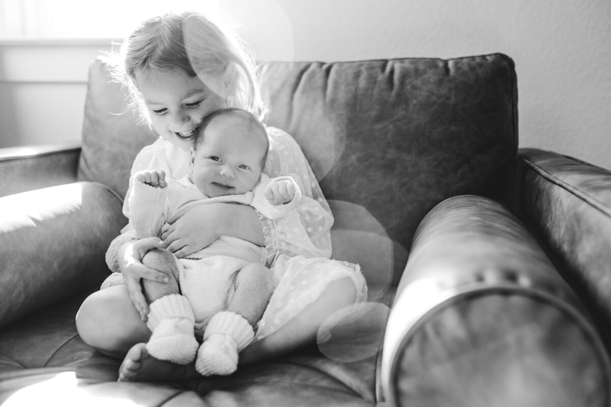 Sister and newborn baby