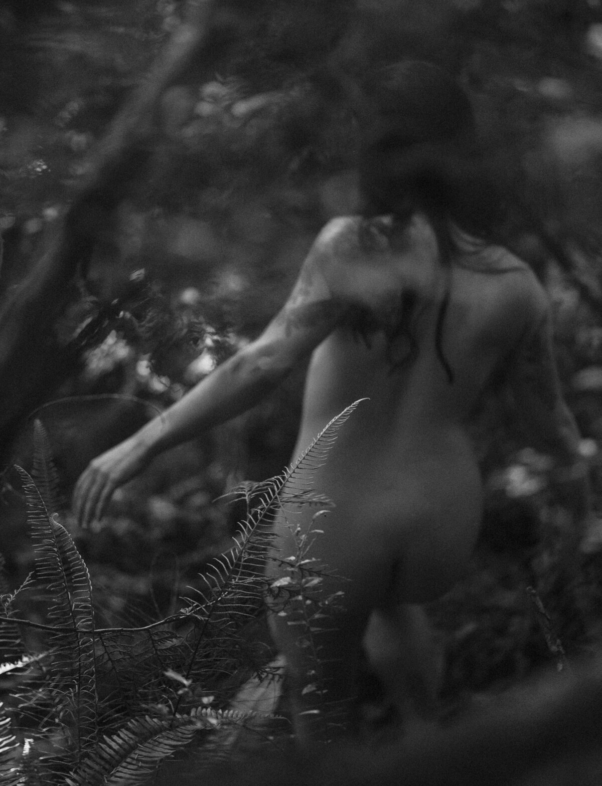 nude woman walks along the lush forest in Oregon