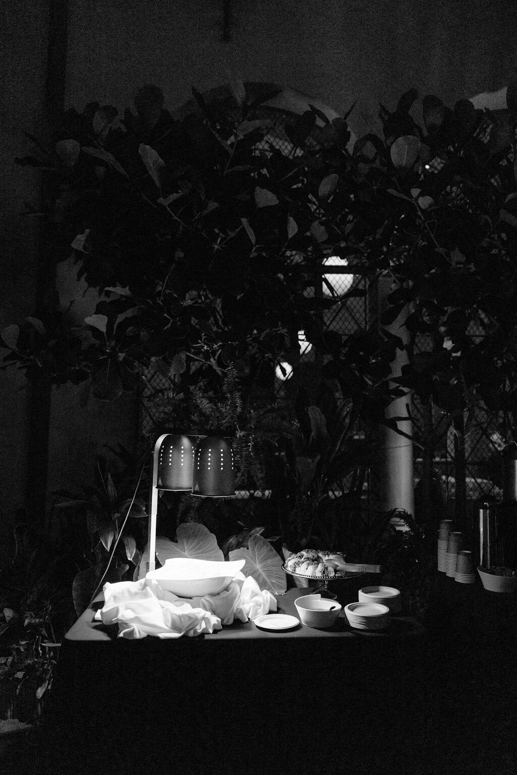Table with food being served under a heating lamp