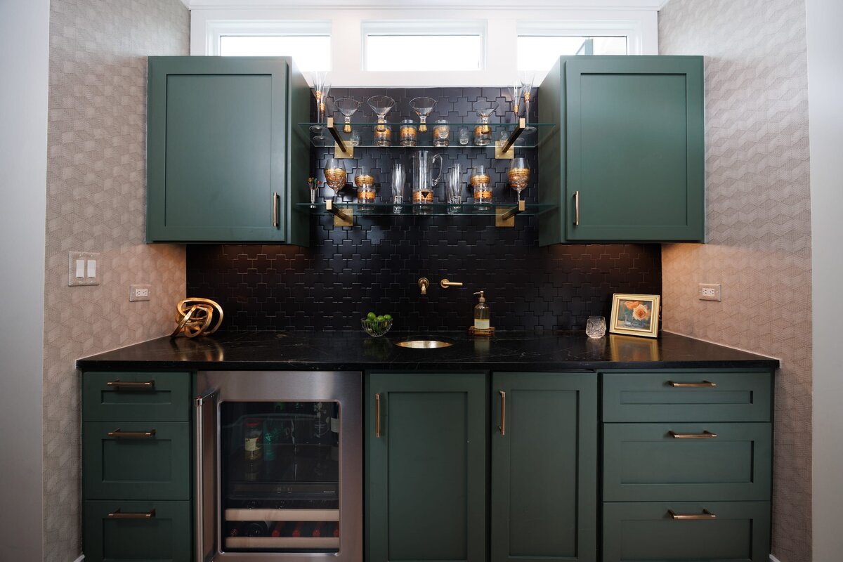 the keeping room interiors primera bar area with green cabinets and dark backspash