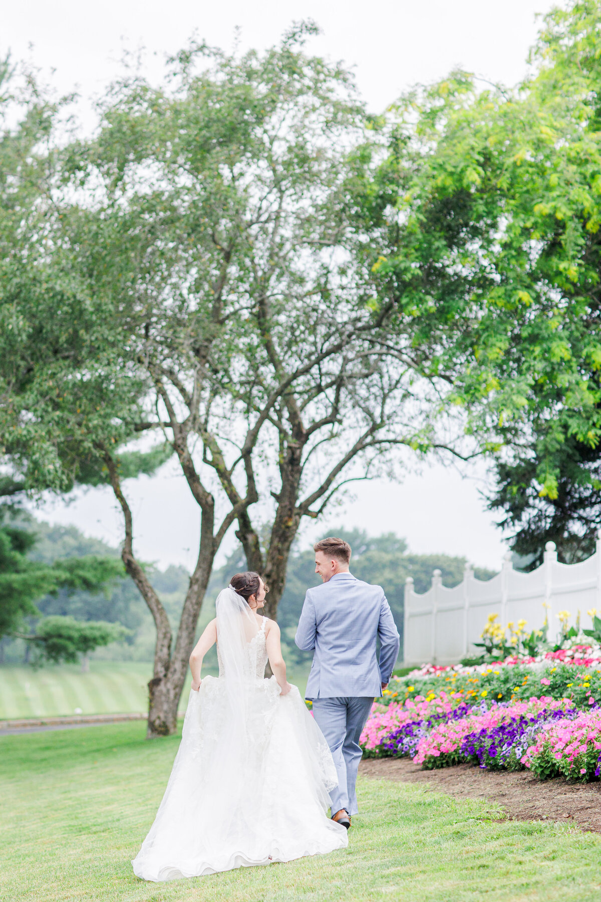 Bride and groom running away from the camera representing romantic Boston wedding pictures