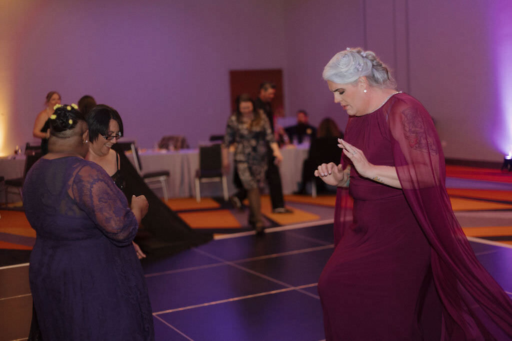 A newlywed couple dancing on a dance floor.