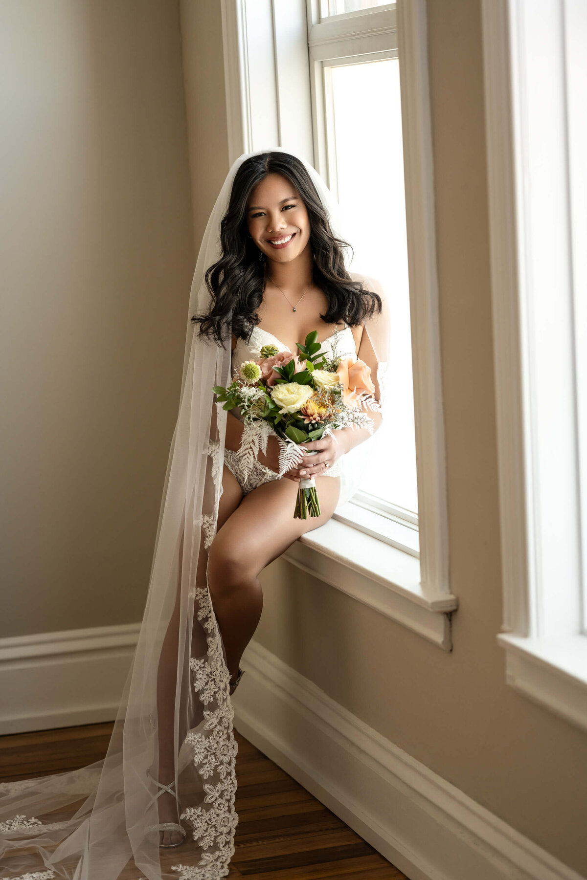 Romantic bridal boudoir session with soft veiled elegance.