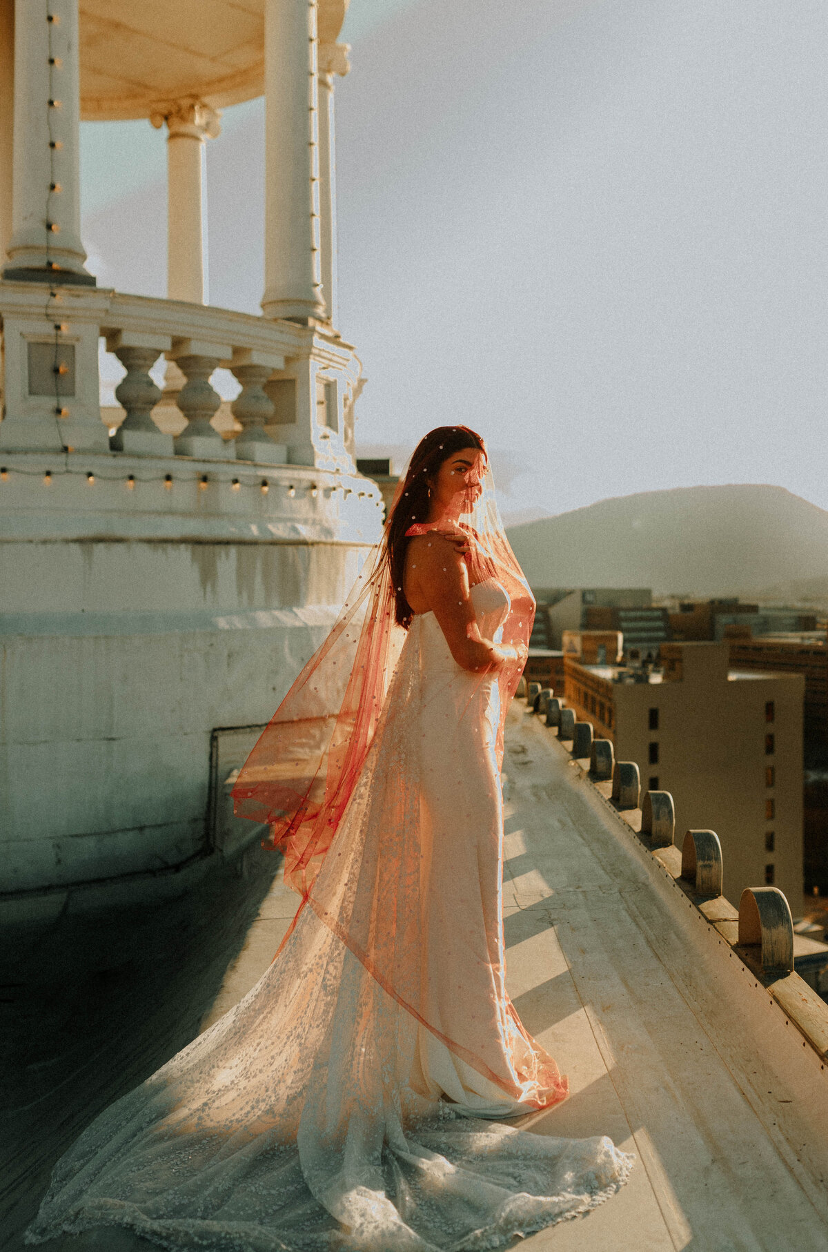 Bride in Red Veil on Rooftop with Mountains