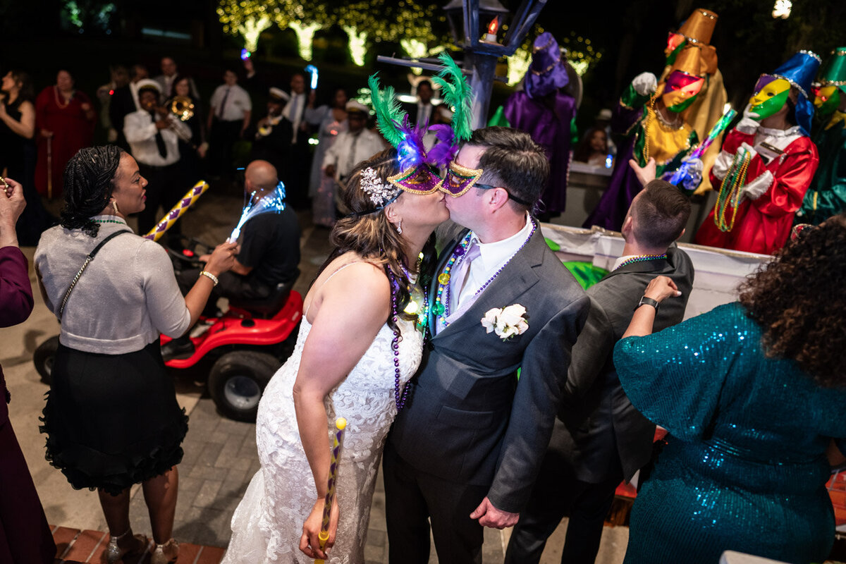 Bride and groom kiss during Southern Oaks Mardi Gras parade