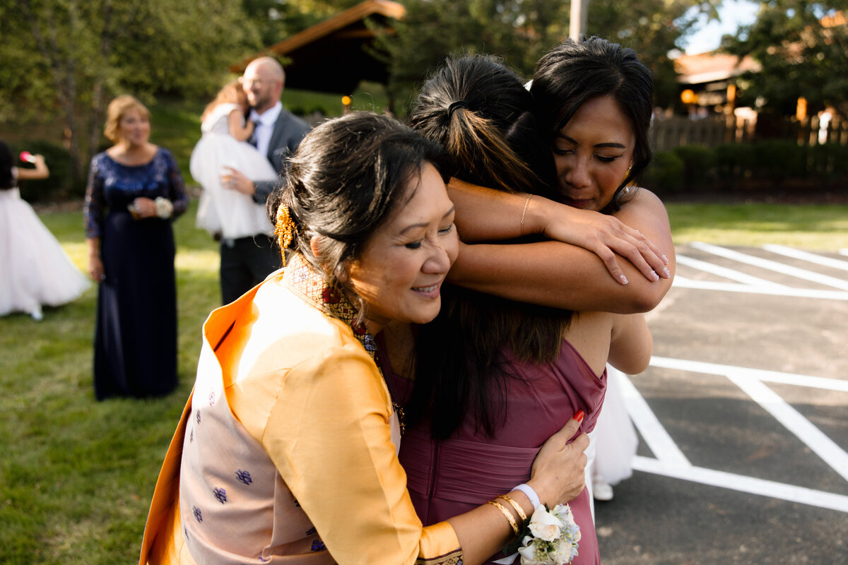 bride-and-mom-hugging-sister