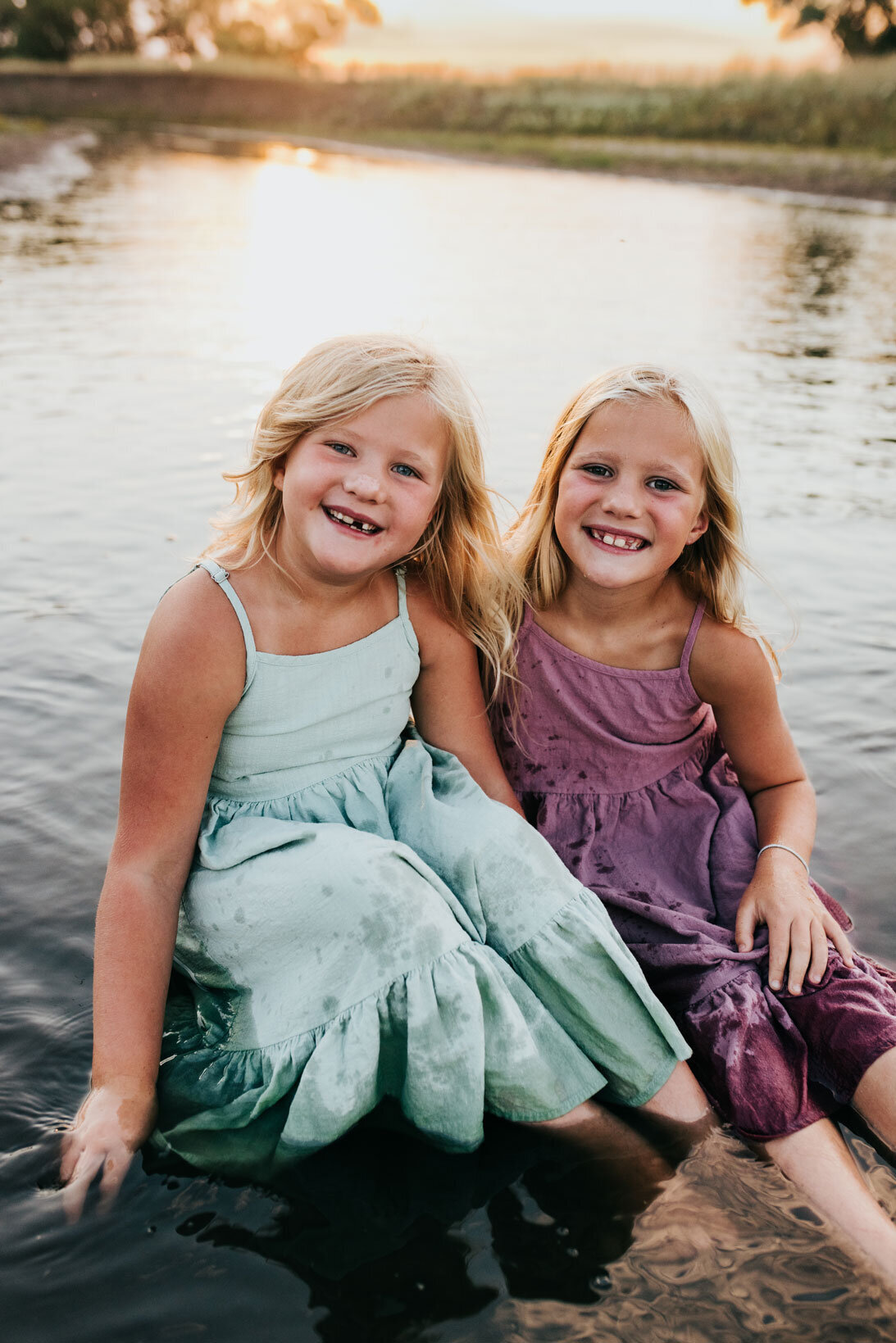 sisters-smiling-having-fun-in-creek