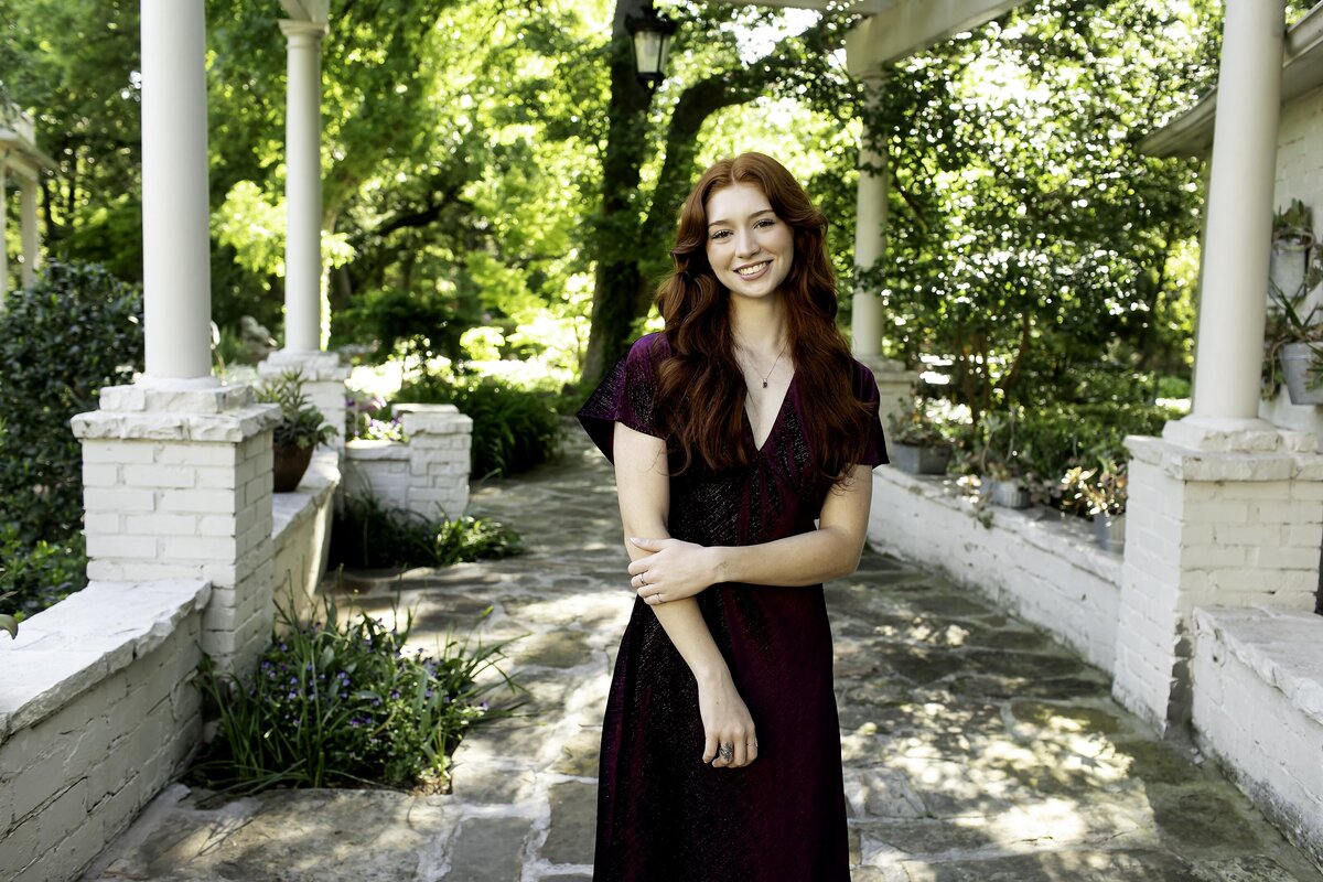 A senior poses with a fun, relaxed attitude, embodying their unique sense of style