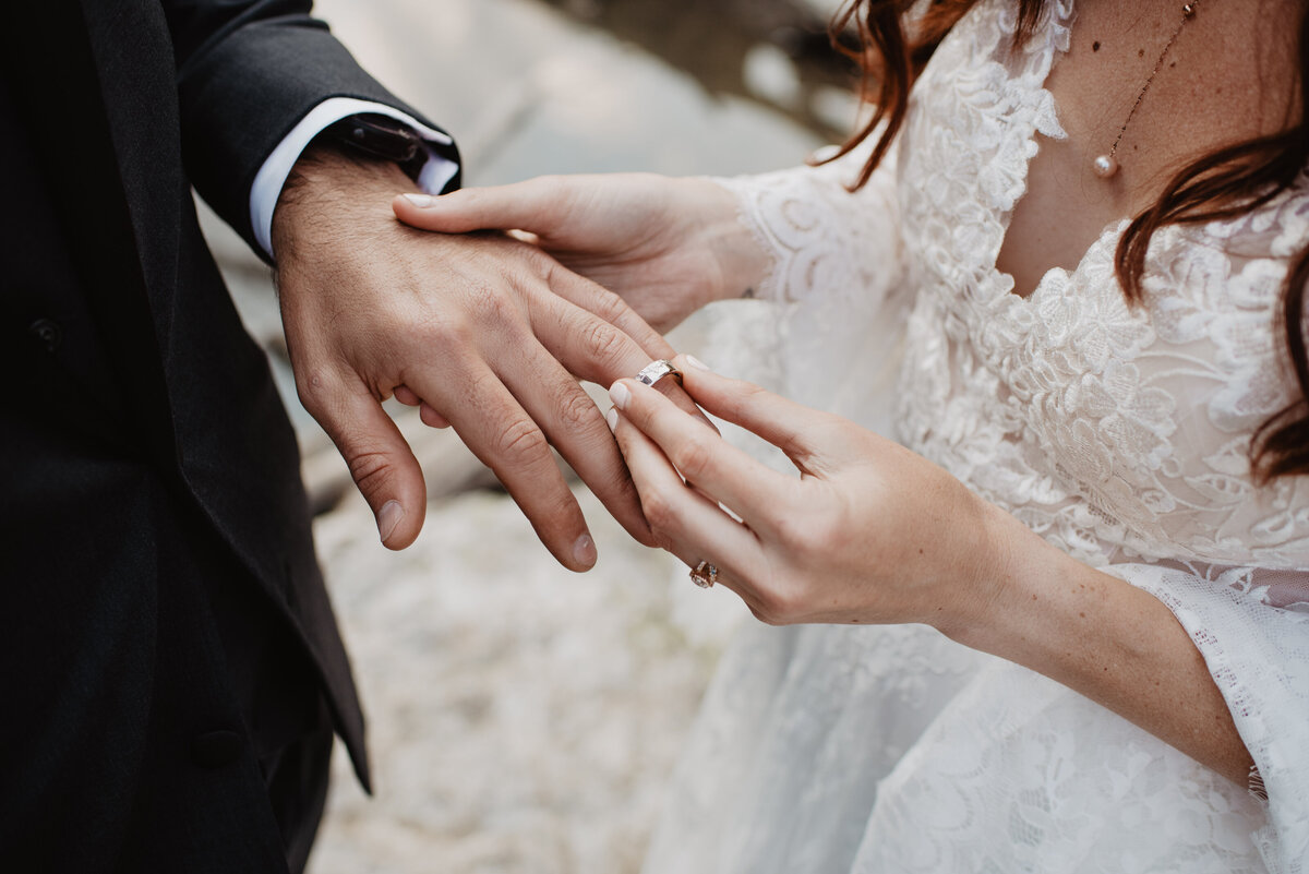 Jackson Hole Photographers capture bride putting ring on groom's finger