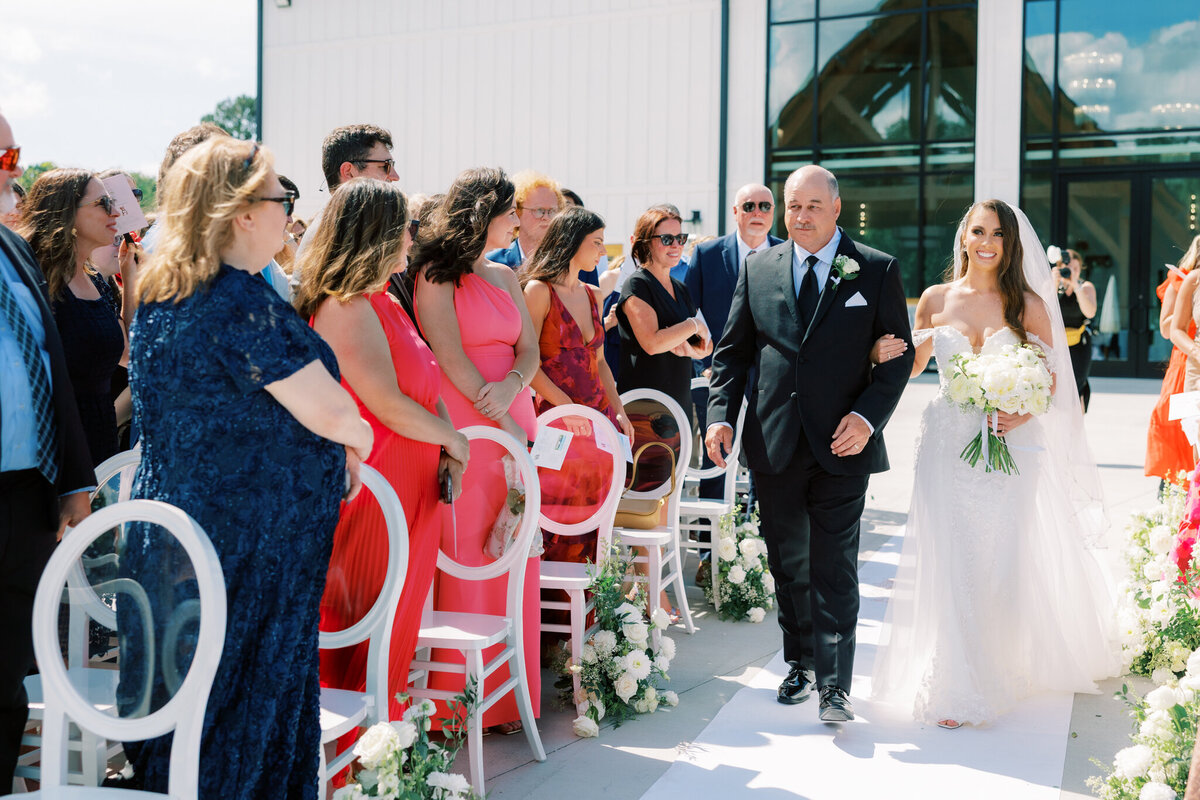Bride walks down the aisle with her father at Nichols Heir, a stunning modern wedding venue in Tennessee