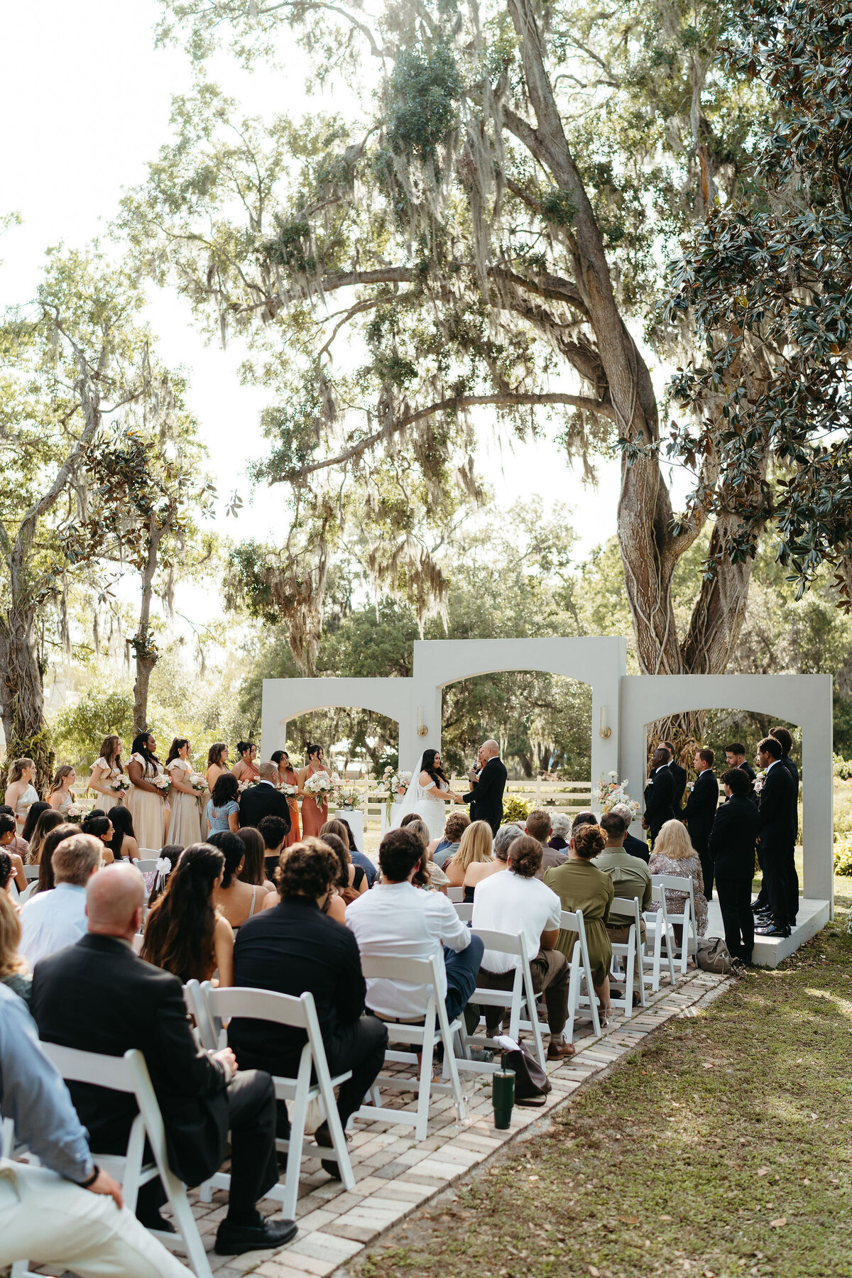 Wedding ceremony under a majestic oak tree at Uliana Estate, a Lakeland Florida wedding venue with timeless charm.