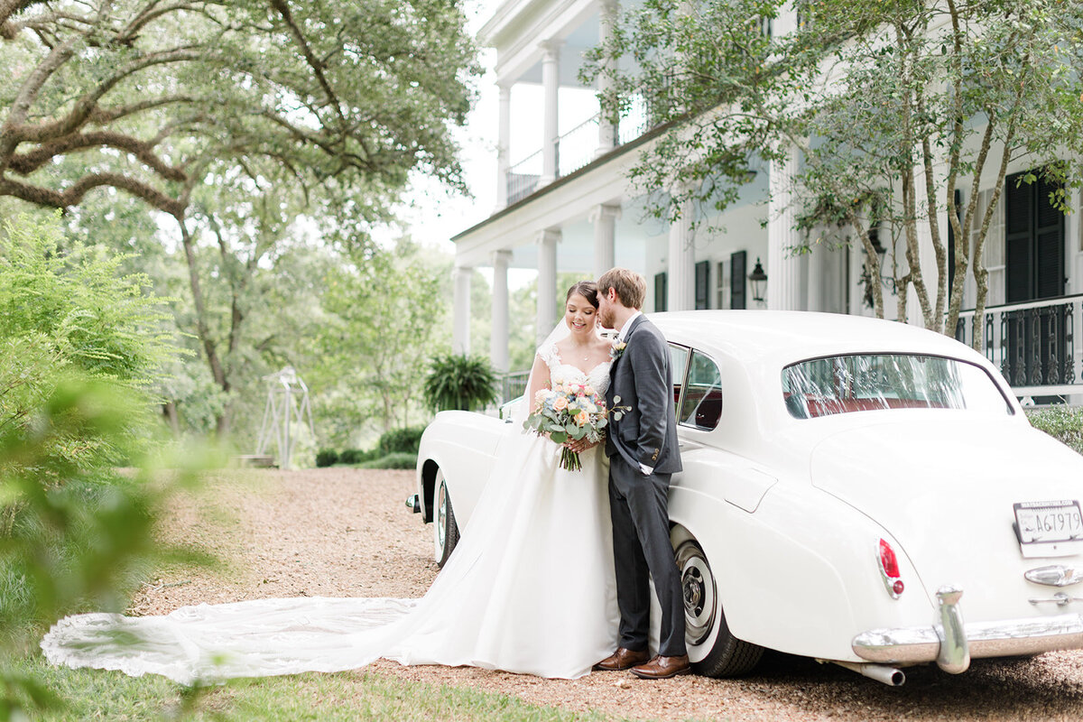 Bride and groom in front of Rolls Royce oat Brandon Hall Plantation; Natchez, Mississippi