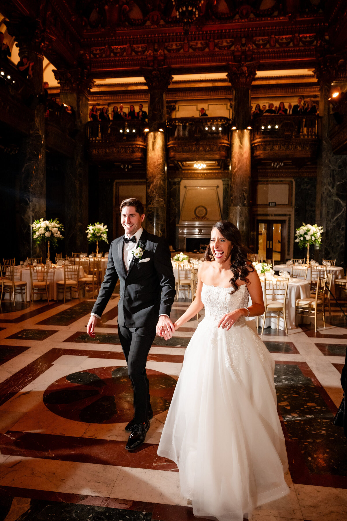 couple being introduced to wedding reception in the music foyer