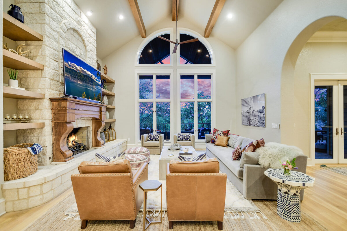 Large living area with large bay window , fireplace and tv