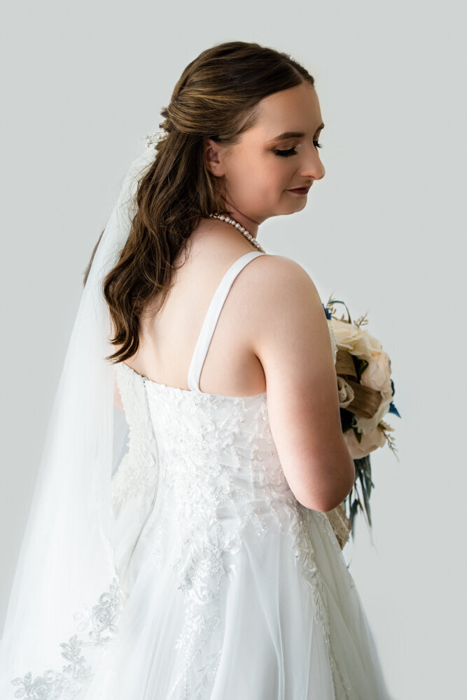 townsville bride looking back at camera holding her bouquet - Townsville Wedding Photography by Jamie Simmons