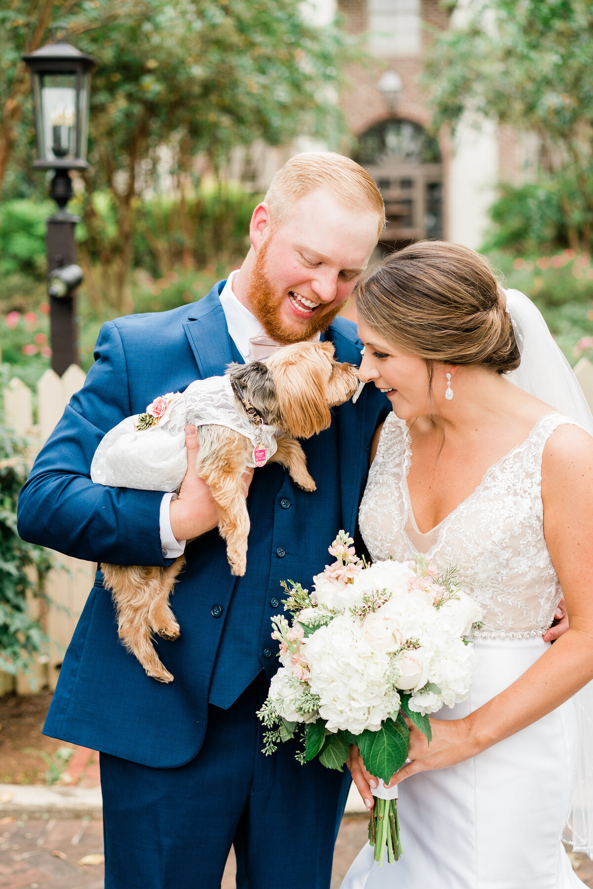 Bride and groom posing with Yorkie in Alabama