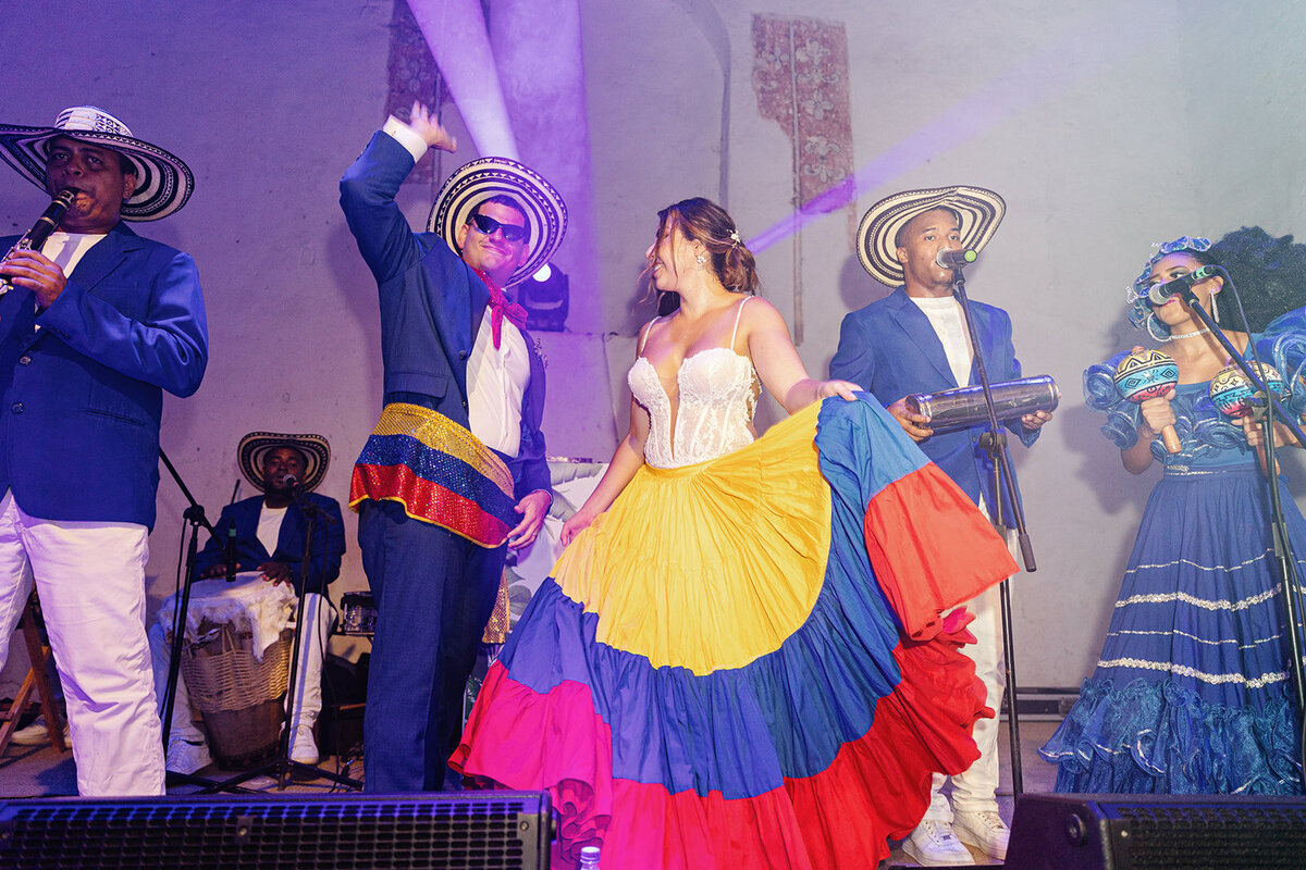 Victoria dances on stage with a live Colombian band, embracing the cultural vibrancy of Cartagena.