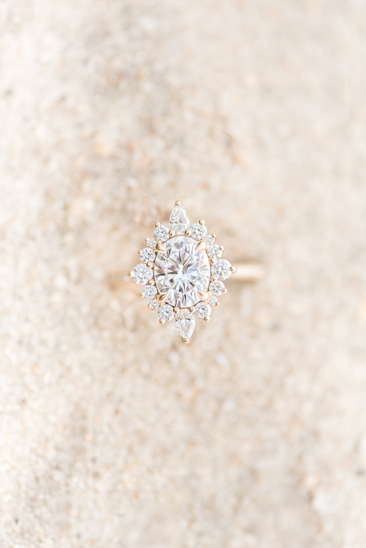 large engagement ring  in sand