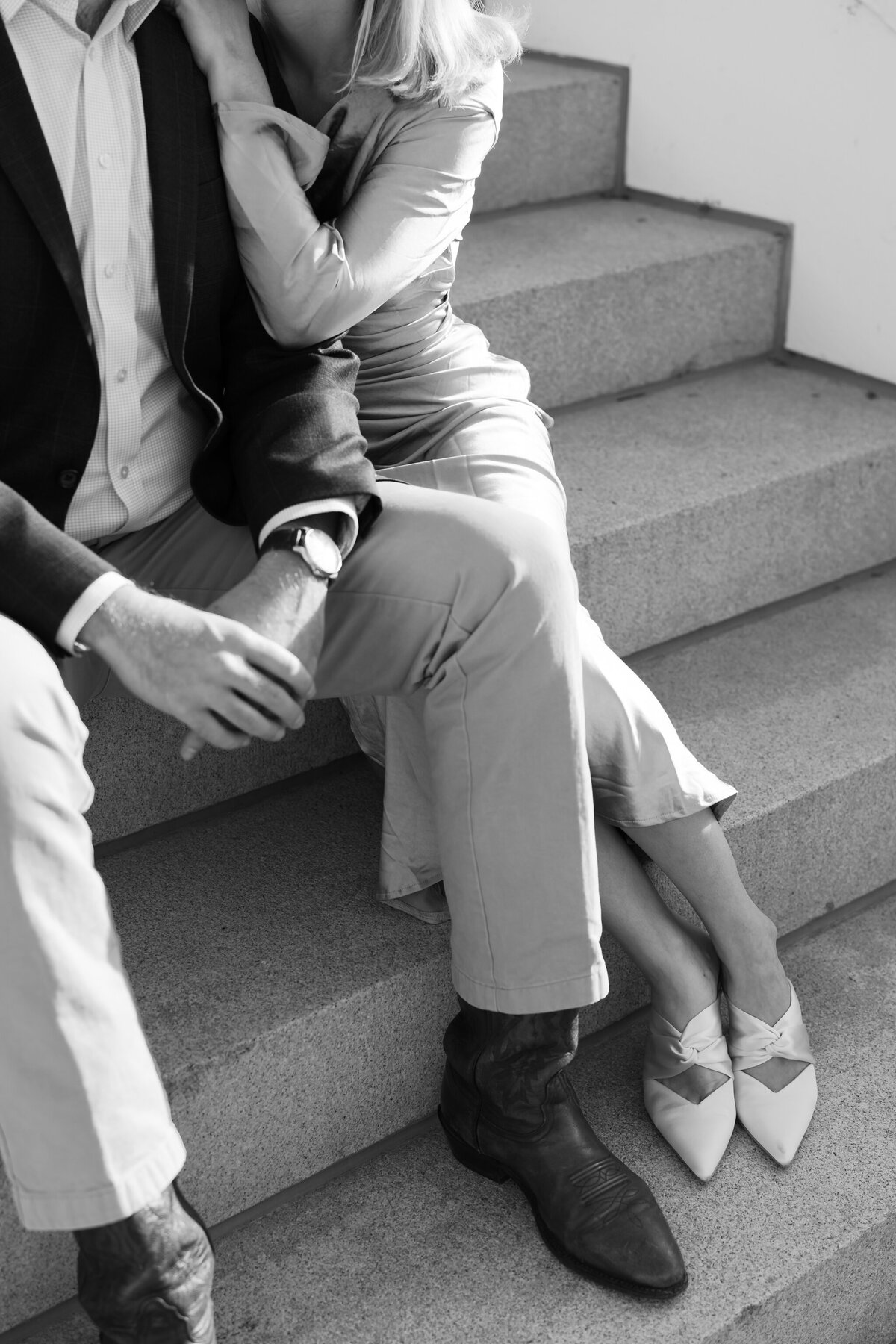 Virginia Capitol Building Engagement Session Richmond VA | black and white closeup image of couple sitting on the white stairs of the Virginia Capitol Building