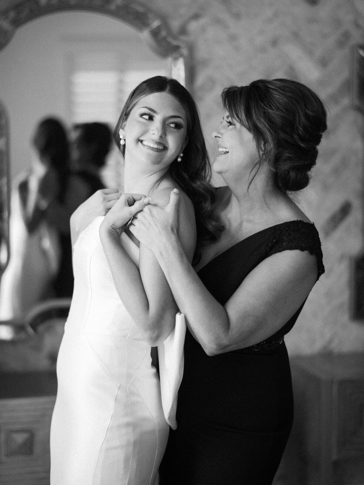 Bride getting dressed in wedding dress