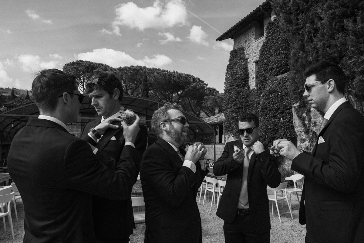 Groomsmen and ushers adjusting ties at wedding in Rome
