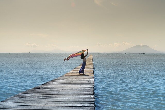 Surrounded by elements of nature on a pier with a gentle breeze.