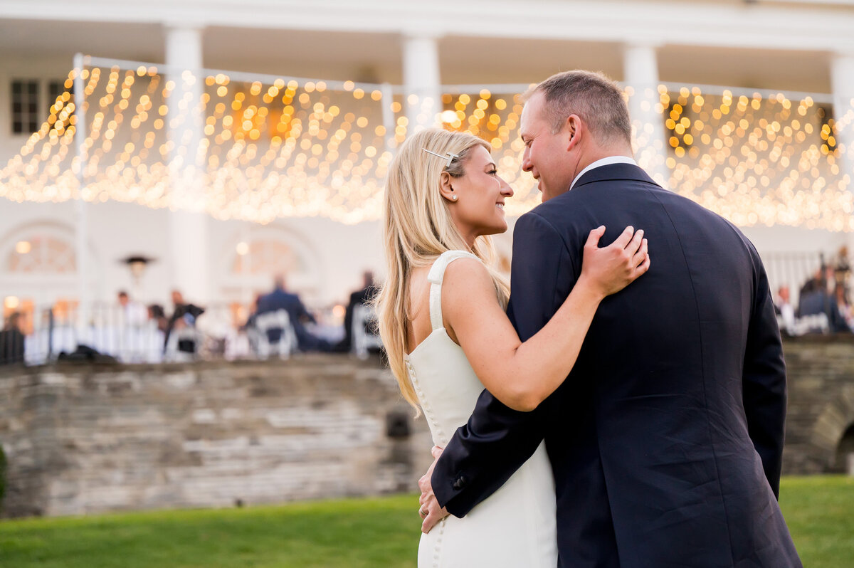 married couple with the pittsburgh field club in the background