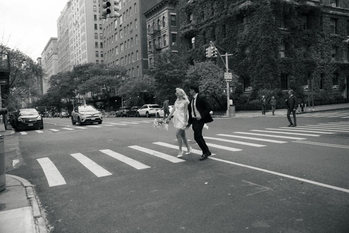 Couple walking hand-in-hand down a quiet NYC street during their elopement.