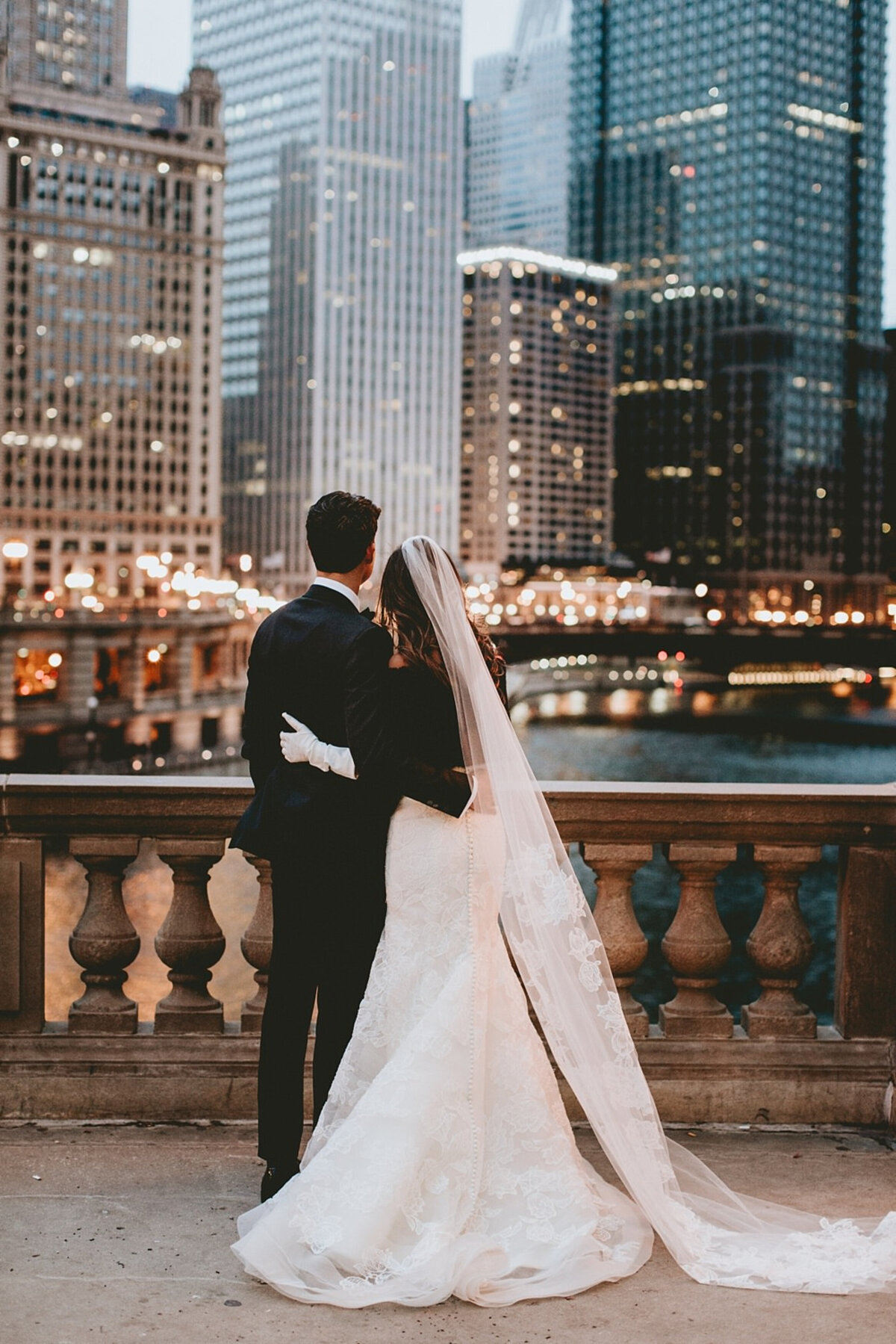 Bride and groom embracing and overlooking downtown Chicago