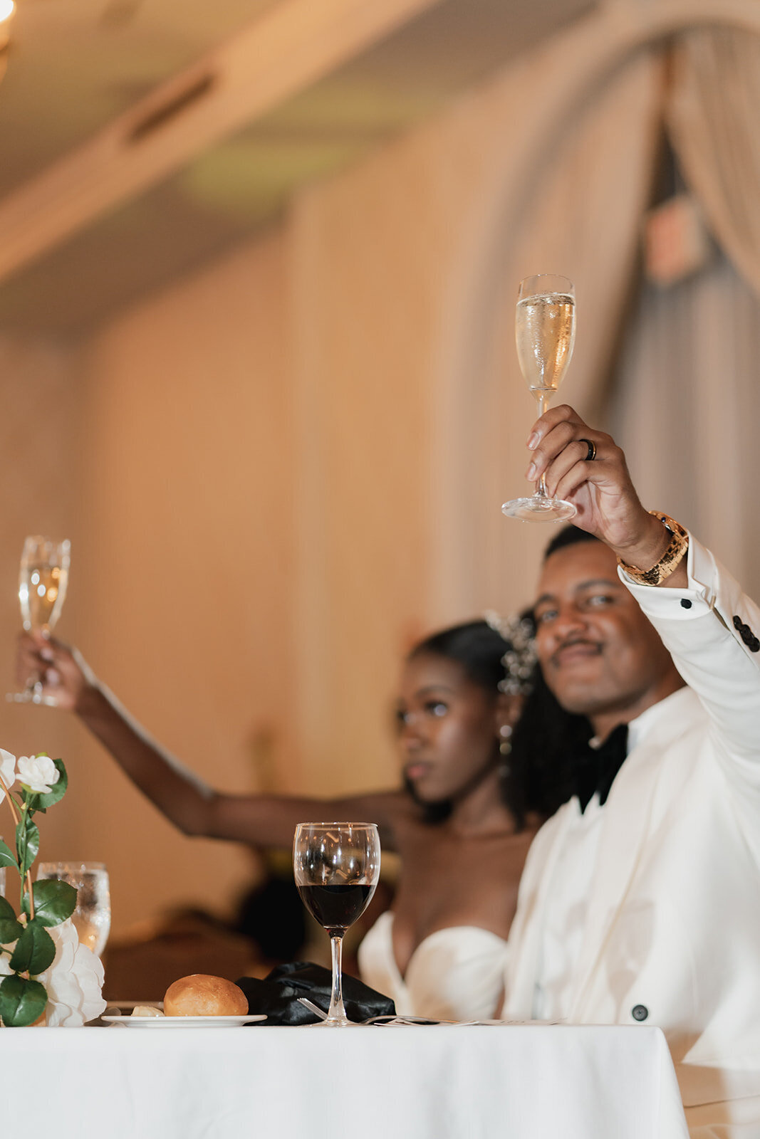 close up of black bride and groom doing champagne toast