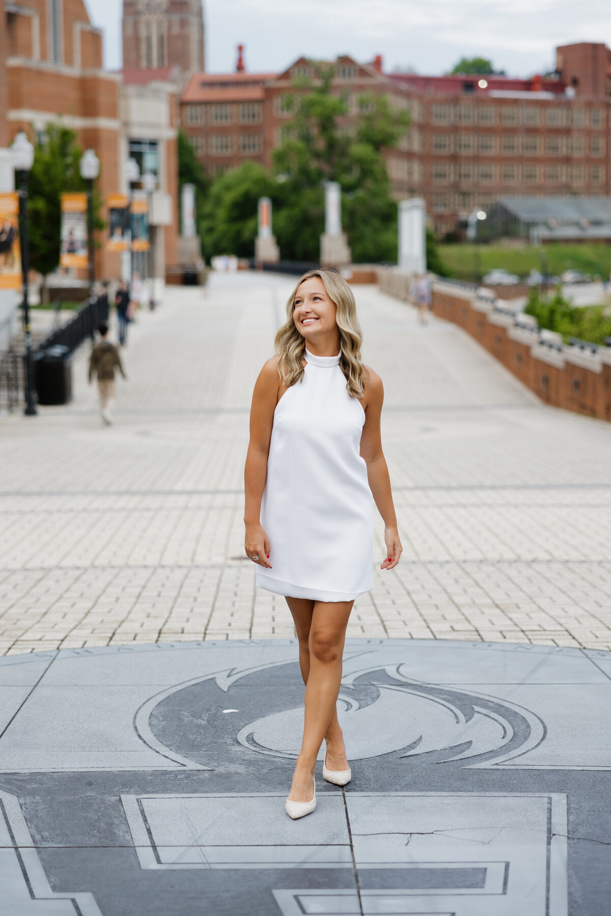 Cambell walks along the walkway at the University of Tennessee during her college senior photos.