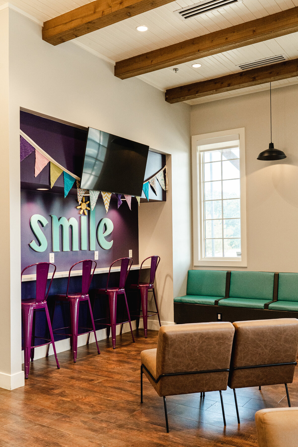 dentist office lobby with purple color accent wall and wooden beams