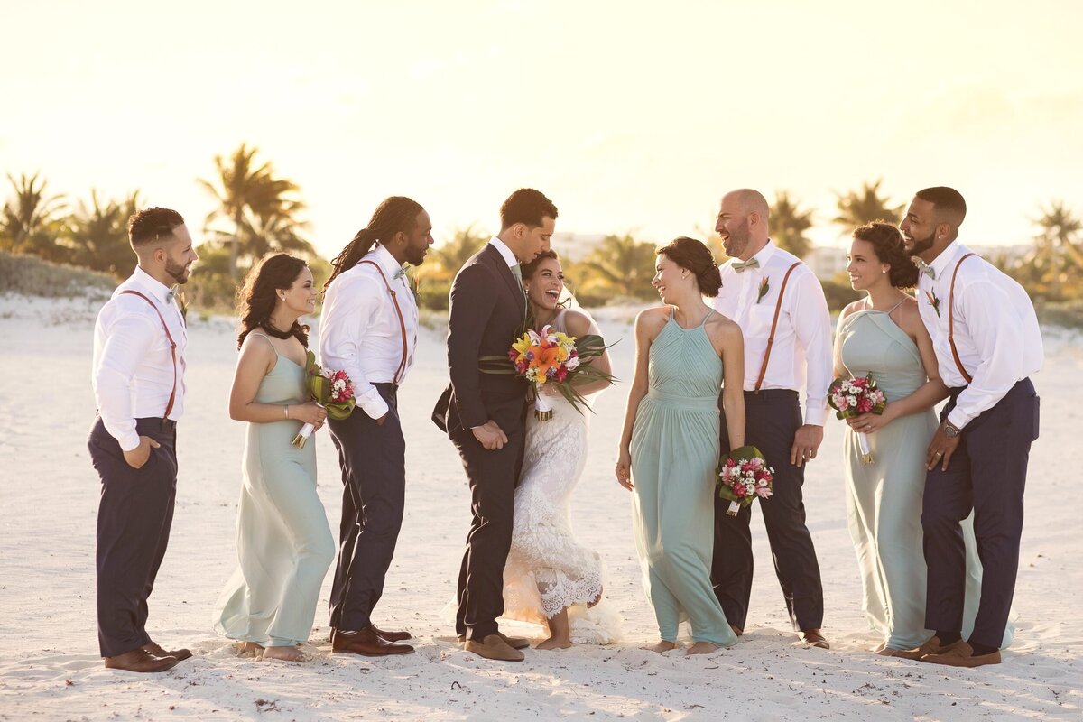 Fun photograph of bridal party laughing together at wedding in Cancun