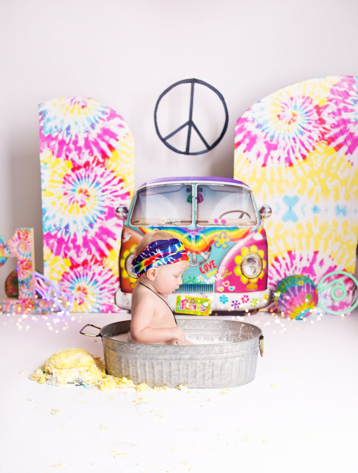 Little boy in wash bin during cake smash photoshoot with Nashville, TN photographer