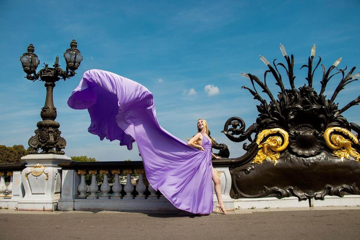 women having a portrait photoshoot in paris wearing a purple flying dress