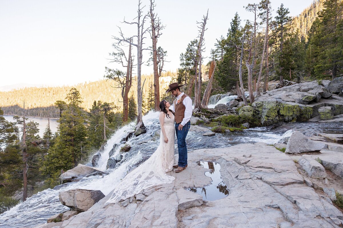 married couple standing near waterfall at Lake Tahoe
