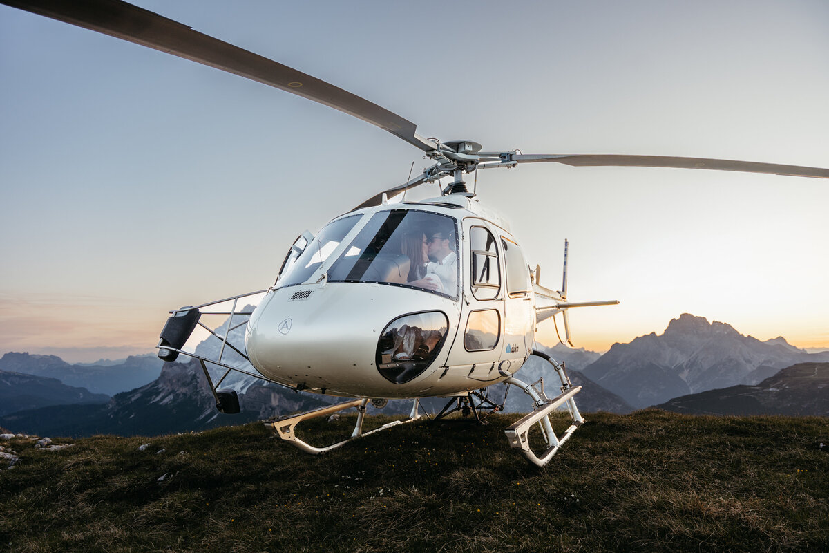 Helicopter flying over Dolomites peaks
