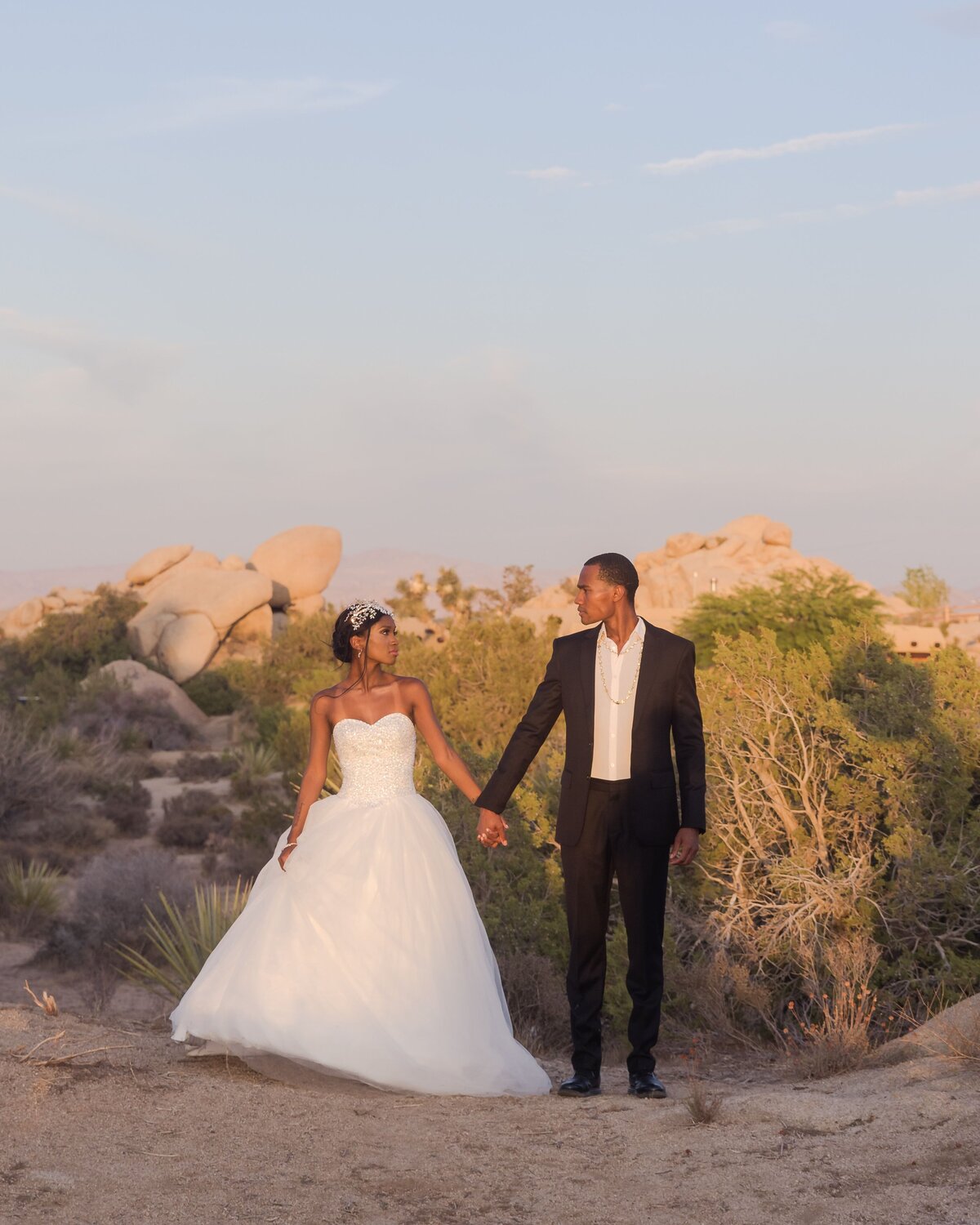 bride and groom holding hands looking at each othr at Southern California wedding